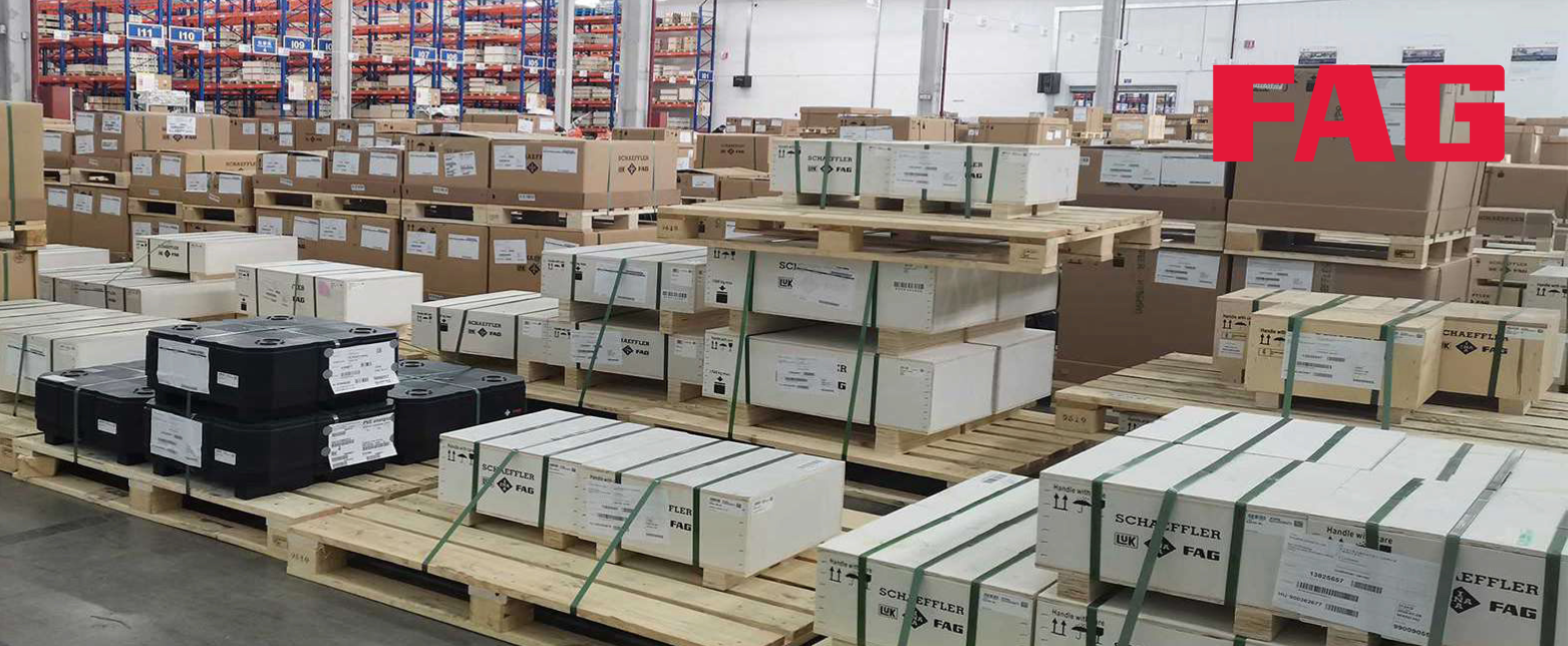 A large, well-stocked FAG warehouse with pallets of Schaeffler bearings and industrial products ready for shipping and distribution.