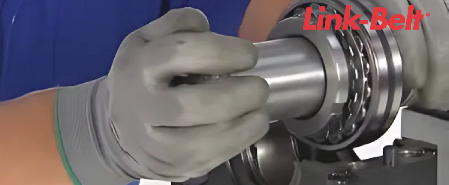 A service technician mounting a Link-Belt spherical roller bearing. A high-performance bearing for industrial machinery and MRO use.